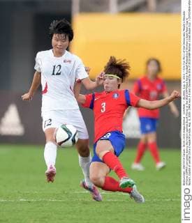 (150808) -- WUHAN, Aug. 8, 2015 -- Kim Yun Mi(L) of the Democratic People s Republic of Korea (DPRK) competes during the match against South Korea at the 2015 EAFF(East Asian Football Federation) Women s East Asian Cup in Wuhan, capital of central China s Hubei Province, Aug. 8, 2015. DPRK won 2-0 and claimed the title of 2015 EAEF Women s East Asian Cup. ) (SP)CHINA-WUHAN-FOOTBALL-EAFF EAST ASIAN CUP 2015-WOMEN-CHAMPIONSHIP chengxmin 