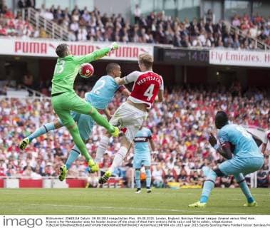 09.08.2015. London, England. Barclays Premier League. Arsenal versus West Ham. Arsenal s Per Mertesacker sees his header bounce off the chest of West Ham United s Adri& xe1;n and fall to safety. xNigelxCookex  ActionPlus11647984