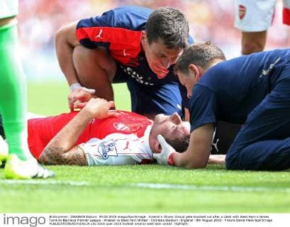Arsenal s Olivier Giroud gets knocked out after a clash with West Ham s James Tomkins Barclays Premier League - Arsenal vs West Ham United - Emirates Stadium -England - 9th August 2015 - Picture David Klein Sportimage EDITORIAL USE ONLY. No use with unauthorised audio, video, data, fixture lists, club league logos or live services. Online in-match use limited to 120 images, no video emulation. No use in betting, games or single club league player publications.