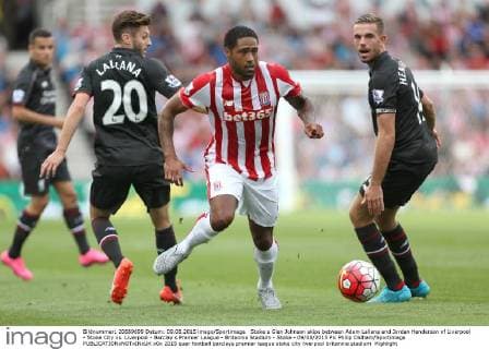 Stoke s Glen Johnson skips between Adam Lallana and Jordan Henderson of Liverpool - Stoke City vs. Liverpool - Barclay s Premier League - Britannia Stadium - Stoke - 09 08 2015 Pic Philip Oldham Sportimage EDITORIAL USE ONLY. No use with unauthorised audio, video, data, fixture lists, club league logos or live services. Online in-match use limited to 120 images, no video emulation. No use in betting, games or single club league player publications.