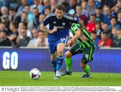 11.08.2015. Cardiff, Wales. Capital One Cup 1st Round. Cardiff versus AFC Wimbledon. Cardiff City s Aron Gunnarsson passes Dannie Bulman. xPaulxJenkinsx  ActionPlus11648594