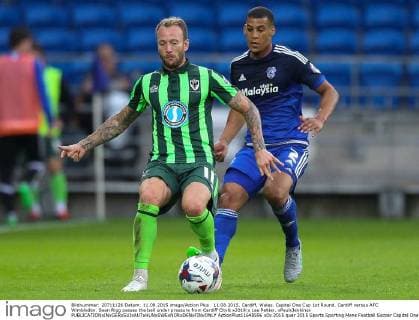 11.08.2015. Cardiff, Wales. Capital One Cup 1st Round. Cardiff versus AFC Wimbledon. Sean Rigg passes the ball under pressure from Cardiff City& x2019;s Lee Peltier. xPaulxJenkinsx  ActionPlus11648596