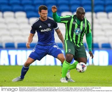 11.08.2015. Cardiff, Wales. Capital One Cup 1st Round. Cardiff versus AFC Wimbledon. AFC Wimbledon s Adebayo Akinfenwa under pressure from Cardiff City& x2019;s Sean Morrison. xPaulxJenkinsx  ActionPlus11648600