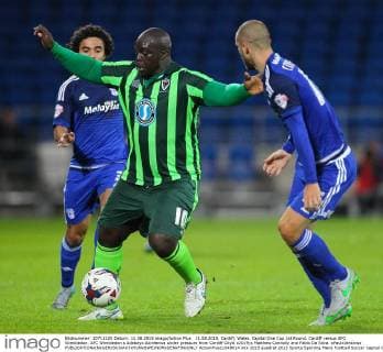 11.08.2015. Cardiff, Wales. Capital One Cup 1st Round. Cardiff versus AFC Wimbledon. AFC Wimbledon s Adebayo Akinfenwa under pressure from Cardiff City& x2019;s Matthew Connolly and Fabio Da Silva. xPaulxJenkinsx  ActionPlus11648614