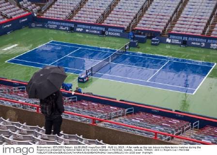 AUG 11, 2015 : A fan waits as the rain delays multiple tennis matches during the Rogers Cup presented by National Bank at the Uniprix Stadium in Montreal, Quebec, Canada. TENNIS: AUG 11 Rogers Cup - Montreal Icon15081102 EDITORIAL USE ONLY