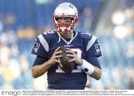 New England Patriots quarterback Tom Brady (12) palms a football during warm ups before the preseason game against the Green Bay Packers at Gillette Stadium in Foxborough, Massachusetts on August 13, 2015. Tom Brady is currently appealing a four game suspension by the NFL American Football Herren USA for playing with tampered footballs in last years AFC Championship game.  BOS20150813105 MATTHEWxHEALEY