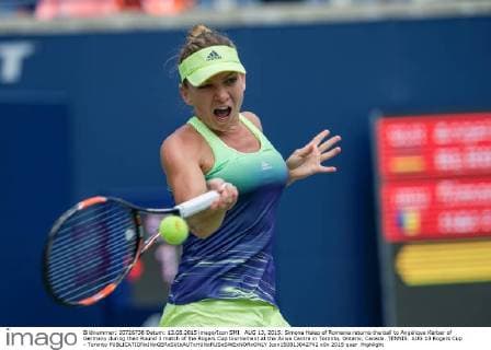 AUG 13, 2015: Simona Halep of Romania returns the ball to Angelique Kerber of Germany during their Round 3 match of the Rogers Cup tournament at the Aviva Centre in Toronto, Ontario, Canada. TENNIS: AUG 13 Rogers Cup - Toronto Icon150813042742 EDITORIAL USE ONLY