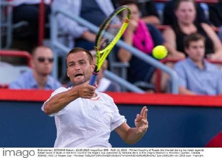 AUG 13, 2015 : Mikhail Youzhny of Russia hits the ball during his match against Rafael Nadal of Spain in the third round of the Rogers Cup presented by National Bank at the Uniprix Stadium in Montreal, Quebec, Canada. TENNIS: AUG 13 Rogers Cup - Montreal Icon15081364 EDITORIAL USE ONLY