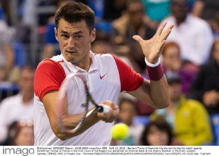 AUG 13, 2015 : Bernard Tomic of Australia hits the ball during his match against Jo-Wilfried Tsonga of France in the third round of the Rogers Cup presented by National Bank at the Uniprix Stadium in Montreal, Quebec, Canada. TENNIS: AUG 13 Rogers Cup - Montreal Icon15081371 EDITORIAL USE ONLY
