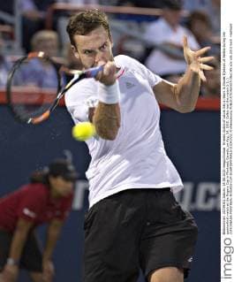 Ernests Gulbis of Latvia hits a return to Novak Djokovic of Serbia during the quarterfinal match at the Rogers Cup in Montreal, Canada, on Aug. 14, 2015. Gulbis lost the match 1-2. ) (SP)CANADA-MONTREAL-ROGERS-CUP-QUARTERFINALS-DJOKOVIC AndrewxSoong 