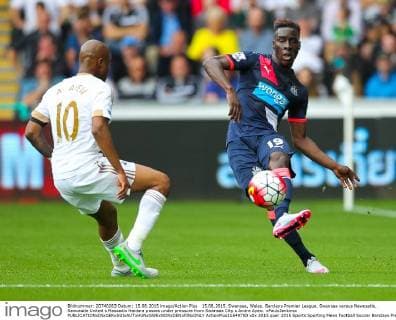 15.08.2015. Swansea, Wales. Barclays Premier League. Swansea versus Newcastle. Newcastle United s Massadio Haidara passes under pressure from Swansea City s Andre Ayew. xPaulxJenkinsx  ActionPlus11649750