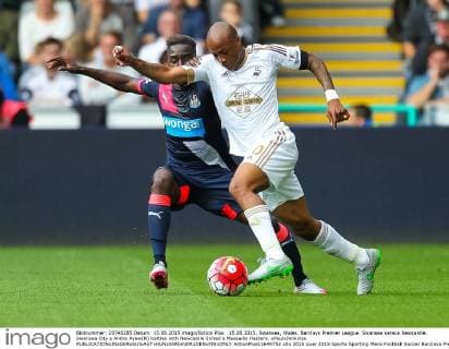 15.08.2015. Swansea, Wales. Barclays Premier League. Swansea versus Newcastle. Swansea City s Andre Ayew(R) battles with Newcastle United s Massadio Haidara. xPaulxJenkinsx  ActionPlus11649752