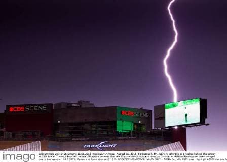 August 15, 2015; Foxborough, MA, USA; A lightning bolt flashes behind the screen at CBS Scene. The MLS Fussball Herren USA game between the New England Revolution and Houston Dynamo at Gillette Stadium has been delayed due to bad weather. MLS 2015: Dynamo vs Revolution AUG 15 - ZUMAc04_