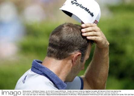 Dustin Johnson holds his head as he walks off the par-4 first hole during the final round of the 97th PGA Golf Herren Championship at Whistling Straits on August 16, 2015 in Kohler, Wisconsin. Johnson carded an four-over-par eight on the hole.  FPX2015081604 FRANKxPOLICH