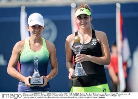 AUG 16, 2015: Belinda Bencic of Switzerland and Simona Halep of Romania pose with their trophies after winning the Rogers Cup final match at the Aviva Centre in Toronto, Ontario, Canada. TENNIS: AUG 16 Rogers Cup - Toronto Icon1508161260 EDITORIAL USE ONLY