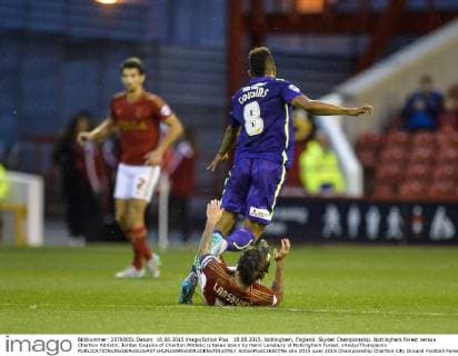 18.08.2015. Nottingham, England. Skybet Championship. Nottingham Forest versus Charlton Athletic. Jordan Cousins of Charlton Athletic is taken down by Henri Lansbury of Nottingham Forest. xAndyxThompsonx  ActionPlus11650796