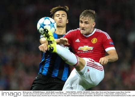 - MANCHESTER, UNITED KINGDOM: Club s Dion Cools and Manchester s Luke Shaw fight for the ball during a soccer game between British club Manchester United ManU FC and Belgian team Club Brugge KV in Manchester, United Kingdom, Tuesday 18 August 2015, the first leg of the play-offs for the UEFA Champions League competition. BRUNOxFAHY  x04682755x