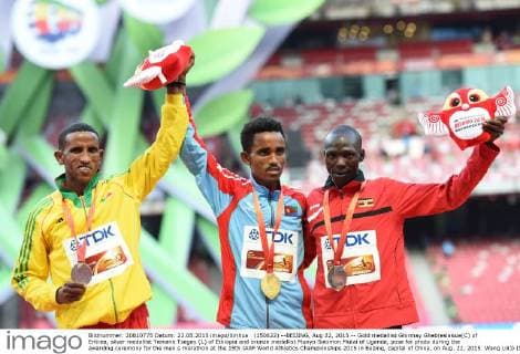 (150822) --BEIJING, Aug 22, 2015 -- Gold medallist Ghirmay Ghebreslassie(C) of Eritrea, silver medallist Yemane Tsegay (L) of Ethiopia and bronze medallist Munyo Solomon Mutai of Uganda, pose for photo during the awarding ceremony for the men s marathon at the 15th IAAF World Athletics Championships 2015 in Beijing, capital of China, on Aug. 22, 2015. Wang Lili)) (SP)CHINA-BEIJING-IAAF WORLD CHAMPIONSHIPS-MEN S MARATHON (CN) YuexYuewei 