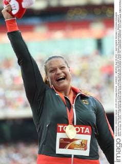 (150823) -- BEIJING, Aug 23,2015 -- Gold medalist Germany s Christina Schwanitz celebrates during the awarding ceremony of the women s shot put final at the 2015 IAAF World Athletics Championships in Beijing, capital of China, on Aug. 23, 2015. ) (SP)CHINA-BEIJING-IAAF WORLD CHAMPIONSHIPS-WOMEN S SHOT PUT AWARDING CEREMONY (CN) YuexYuewei 