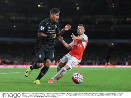 Arsenal s Santi Cazorla tussles with Liverpool s Roberto Firmino Barclays Premier League - Arsenal vs Liverpool - Emirates Stadium -England - 24th August 2015 - Picture David Klein Sportimage EDITORIAL USE ONLY. No use with unauthorised audio, video, data, fixture lists, club league logos or live services. Online in-match use limited to 120 images, no video emulation. No use in betting, games or single club league player publications.