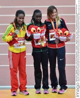 (150825) -- BEIJING, Aug. 25, 2015 -- Gold medalist Kenya s Vivian Jepkemoi Cheruiyot (C), silver medalist Ethiopia s Gelete Burka (L) and bronze medalist Emily Infeld of the United States celebrate during the awarding ceremony of the women s 10000m event at the 2015 IAAF World Championships at the Bird s Nest National Stadium in Beijing, capital of China, Aug. 25, 2015. ) (SP)CHINA-BEIJING-IAAF WORLD CHAMPIONSHIPS-WOMEN S 10000M AWARDING CEREMONY (CN) LixWen 