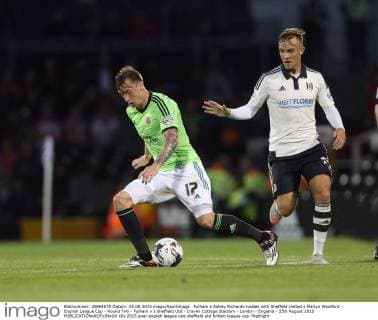 Fulham s Ashley Richards tussles with Sheffield United s Martyn Woolford - English League Cup - Round Two - Fulham v s Sheffield Utd - Craven Cottage Stadium - London - England - 25th August 2015 EDITORIAL USE ONLY. No use with unauthorised audio, video, data, fixture lists, club league logos or live services. Online in-match use limited to 120 images, no video emulation. No use in betting, games or single club league player publications.