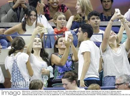 Fans take selfies with Kendall Jenner, Gigi Hadid and Joe Jonas in between games when Venus Williams plays Serena Williams in Arthur Ashe Stadium on day 9 at the US Open Tennis Championships at the USTA Billie Jean King National Tennis Center in New York City on September 8, 2015.  NYP20150908122 JOHNxANGELILLO