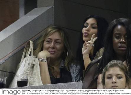 Kim Kardashian holds up a peace sign when she watches Venus Williams play Serena Williams in Arthur Ashe Stadium on day 9 at the US Open Tennis Championships at the USTA Billie Jean King National Tennis Center in New York City on September 8, 2015.  NYP20150908131 JOHNxANGELILLO