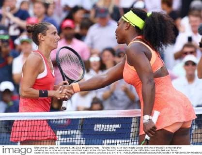 Roberta Vinci (L) of Italy meets Serena Williams of the USA at the net after defeating her in three sets in their semi-final match at the US Open Tennis Championships at the USTA Billie Jean King National Tennis Center in New York City on September 11, 2015. Williams, who lost 2-6, 6-4, 6-4, .  NYP20150911304 MONIKAxGRAFF