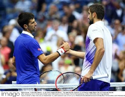 Top seed Novak Djokovic (L) of Serbia meets Marin Cilic of Croatia at the net after defeating him in three sets of their semi-final match at the US Open Tennis Championships at the USTA Billie Jean King National Tennis Center in New York City on September 11, 2015.Djokovic won 6-0,6-1,6-2.  NYP20150911325 MONIKAxGRAFF