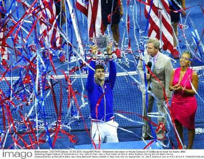 Streamers rain down on Novak Djokovic of Serbia as he hoist his trophy after defeating Roger Federer of Switzerland in four sets of their men s final match at Arthur Ashe Stadium during the US Open Tennis Championships at the USTA Billie Jean King National Tennis Center in New York City on September 13, 2015. Djokovic won 6-4,5-7,6-4,6-4.  NYP20150913326 MONIKAxGRAFF