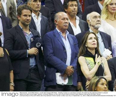 Bradley Cooper (L) and Sean Connery (R) stand as the national anthem is played before the start of the Roger Federer vs Novak Djokovic in the men s final match at Arthur Ashe Stadium during the US Open Tennis Championships at the USTA Billie Jean King National Tennis Center in New York City on September 13, 2015.  NYP20150913329 MONIKAxGRAFF