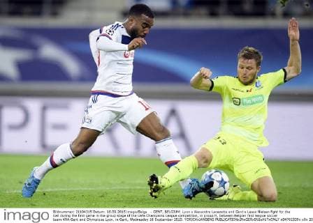 - GENT, BELGIUM: Lyon s Alexandre Lacazette and Gent s Lasse Nielsen fight for the ball during the first game in the group stage of the Uefa Champions League competition, in group H, between Belgian first league soccer team KAA Gent and Olympique Lyon, in Gent, Wednesday 16 September 2015. YORICKxJANSENS  x04701509x