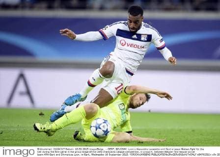 - GENT, BELGIUM: Lyon s Alexandre Lacazette and Gent s Lasse Nielsen fight for the ball during the first game in the group stage of the Uefa Champions League competition, in group H, between Belgian first league soccer team KAA Gent and Olympique Lyon, in Gent, Wednesday 16 September 2015. YORICKxJANSENS  x04701511x