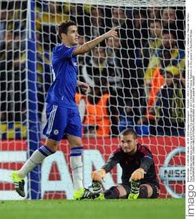 Football - 2015 2016 Champions League - Group G: Chelsea vs. Maccabi Tel Aviv Oscar of Chelsea celebrates scoring goal 2 from the penalty spot with a dejected Predrag Rajkovic on the ground at Stamford Bridge. COLORSPORT ANDREW COWIE 