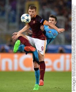 (150917) -- ROME, Sept. 16, 2015 -- Barcelona s Gerard Pique (R) challenges AS Roma s Edin Dzeko during their Champions League Group E stage match at the Olympic stadium in Rome, Italy, Sept. 16, 2015.The match tied 1-1. ) (SP)ITALY-ROME-SOCCER-UEFA CHAMPIONS LEAGUE-ROMA VS BARCELONA AlbertoxLingria 