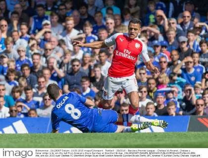 Football - 2015 16 - Barclays Premier League - Chelsea Vs Arsenal. Chelsea s Oscar slides in to win the ball from Arsenal s Alexis Sanchez at Stamford Bridge. COLORSPORT DANIEL BEARHAM  che_ars