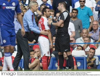 Football - 2015 16 - Barclays Premier League - Chelsea Vs Arsenal. Arsenal s Santi Cazorla is pushed away by Arsene Wenger from questioning fourth official Michael Oliver after being sent off at Stamford Bridge. COLORSPORT DANIEL BEARHAM  che_ars