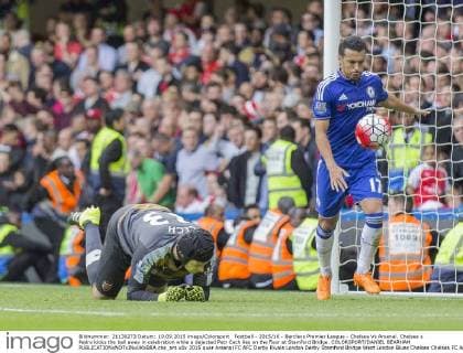 Football - 2015 16 - Barclays Premier League - Chelsea Vs Arsenal. Chelsea s Pedro kicks the ball away in celebration while a dejected Petr Cech lies on the floor at Stamford Bridge. COLORSPORT DANIEL BEARHAM  che_ars