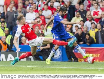 Football - 2015 16 - Barclays Premier League - Chelsea Vs Arsenal. Arsenal s Calum Chambers flies into tackle Chelsea s Diego Costa at Stamford Bridge. COLORSPORT DANIEL BEARHAM  che_ars