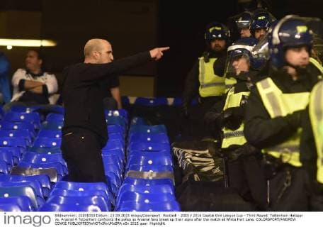 Football - 2015 2016 Capital One League Cup - Third Round: Tottenham Hotspur vs. Arsenal A Tottenham confronts the police as Arsenal fans break up their signs after the match at White Hart Lane. COLORSPORT ANDREW COWIE 