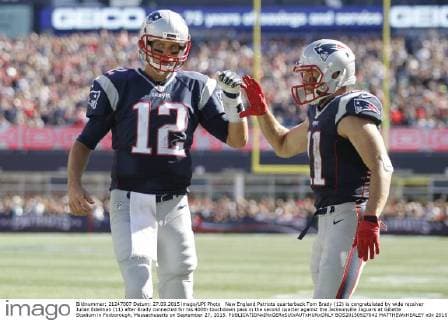 New England Patriots quarterback Tom Brady (12) is congratulated by wide receiver Julian Edelman (11) after Brady connected for his 400th touchdown pass in the second quarter against the Jacksonville Jaguars at Gillette Stadium in Foxborough, Massachusetts on September 27, 2015.  BOS20150927042 MATTHEWxHEALEY