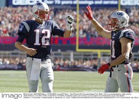 New England Patriots quarterback Tom Brady (12) is congratulated by wide receiver Julian Edelman (11) after Brady connected for his 400th touchdown pass in the second quarter against the Jacksonville Jaguars at Gillette Stadium in Foxborough, Massachusetts on September 27, 2015.  BOS2015092704 MATTHEWxHEALEY