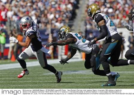 New England Patriots wide receiver Danny Amendola (80) dodges a tackle by Jacksonville Jaguars linebacker Telvin Smith (50) on a reception in the second quarter at Gillette Stadium in Foxborough, Massachusetts on September 27, 2015. The Patriots defeated the Jaguars 51-17.  BOS2015092710 MATTHEWxHEALEY