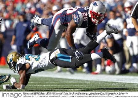 New England Patriots running back James White (28) is upended by Jacksonville Jaguars cornerback Demetrius McCray (35) nine-yard reception in the fourth quarter at Gillette Stadium in Foxborough, Massachusetts on September 27, 2015. The Patriots defeated the Jaguars 51-17.  BOS2015092713 MATTHEWxHEALEY