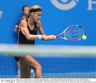 Anna Karolina Schmiedlova of Slovakia returns a shot to Caroline Wozniacki of Denmark in their second-round match of the women s singles during the 2015 WTA Tennis Damen Wuhan Open tennis tournament in Wuhan city, central China s Hubei province, 29 September 2015. Fourth seed Caroline Wozniacki of Denmark lost her second round match to unseeded Anna Karolina Schmiedlova of Slovakia 1-2 (6 1, 4 6, 6 7) in a marathon three hour match during the 2015 Wuhan Open on Tuesday (29 September 2015), further thinning out the ranks of the top seed players at the tournament. Fourth seed Wozniacki knocked out from Wuhan Open  20150929_50765