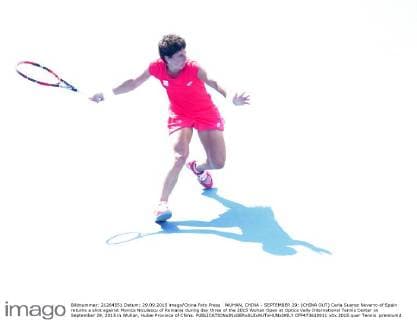 WUHAN, CHINA - SEPTEMBER 29: (CHINA OUT) Carla Suarez Navarro of Spain returns a shot against Monica Niculescu of Romania during day three of the 2015 Wuhan Open at Optics Vally International Tennis Center on September 29, 2015 in Wuhan, Hubei Province of China.  CFP473610911 