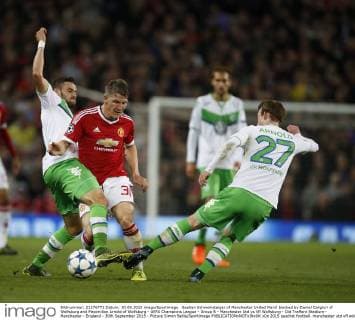 Bastian Schweinsteiger of Manchester United ManU blocked by Daniel Caligiuri of Wolfsburg and Maximilian Arnold of Wolfsburg - UEFA Champions League - Group B - Manchester Utd vs Vfl Wolfsburg - Old Trafford Stadium - Manchester - England - 30th September 2015 - Picture Simon Bellis Sportimage EDITORIAL USE ONLY. No use with unauthorised audio, video, data, fixture lists, club league logos or live services. Online in-match use limited to 120 images, no video emulation. No use in betting, games or single club league player publications.