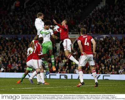 Nicklas Bendtner of Wolfsburg header is blocked the arm of Chris Smalling of Manchester United ManU - UEFA Champions League - Group B - Manchester Utd vs Vfl Wolfsburg - Old Trafford Stadium - Manchester - England - 30th September 2015 - Picture Simon Bellis Sportimage EDITORIAL USE ONLY. No use with unauthorised audio, video, data, fixture lists, club league logos or live services. Online in-match use limited to 120 images, no video emulation. No use in betting, games or single club league player publications.