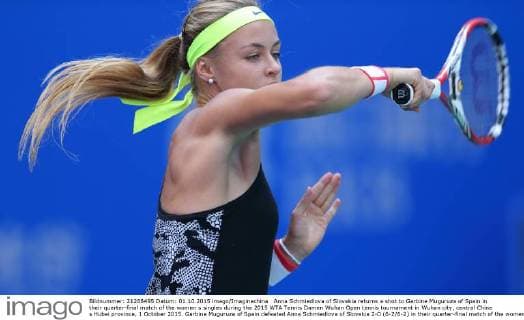 Anna Schmiedlova of Slovakia returns a shot to Garbine Muguruza of Spain in their quarter-final match of the women s singles during the 2015 WTA Tennis Damen Wuhan Open tennis tournament in Wuhan city, central China s Hubei province, 1 October 2015. Garbine Muguruza of Spain defeated Anna Schmiedlova of Slovakia 2-0 (6-2 6-2) in their quarter-final match of the women s singles during the 2015 WTA Wuhan Open tennis tournament in Wuhan city, central China s Hubei province, on Thursday (1 October 2015). Garbine Muguruza beats Anna Schmiedlova to advance at Wuhan Open  pbu339413_06